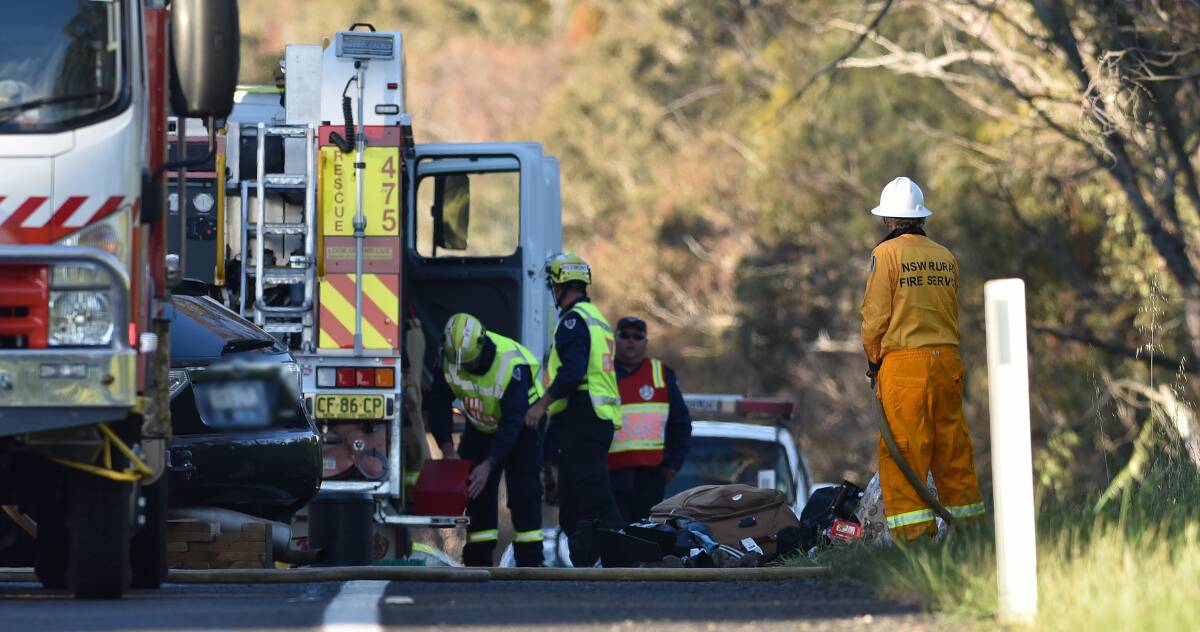 HIGHWAY HORROR:Emergency services at the scene of the head-on collision south of Uralla which killed two men, including a UNE student. Photo: Gareth Gardner