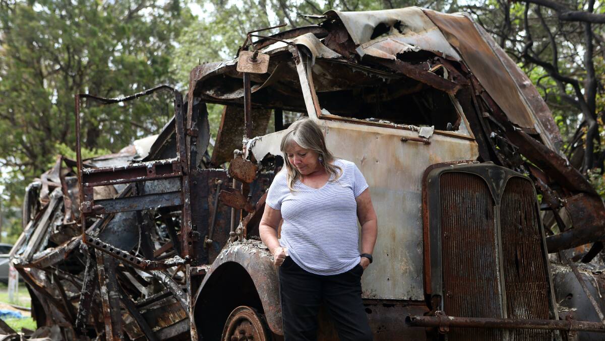 Gail Hodgson inspects the ruins of her Mallacoota home.