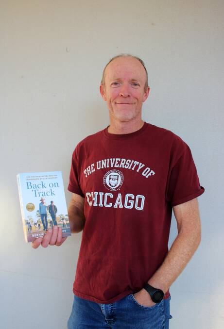 Author James Knight with a copy of Back on Track earlier this year.