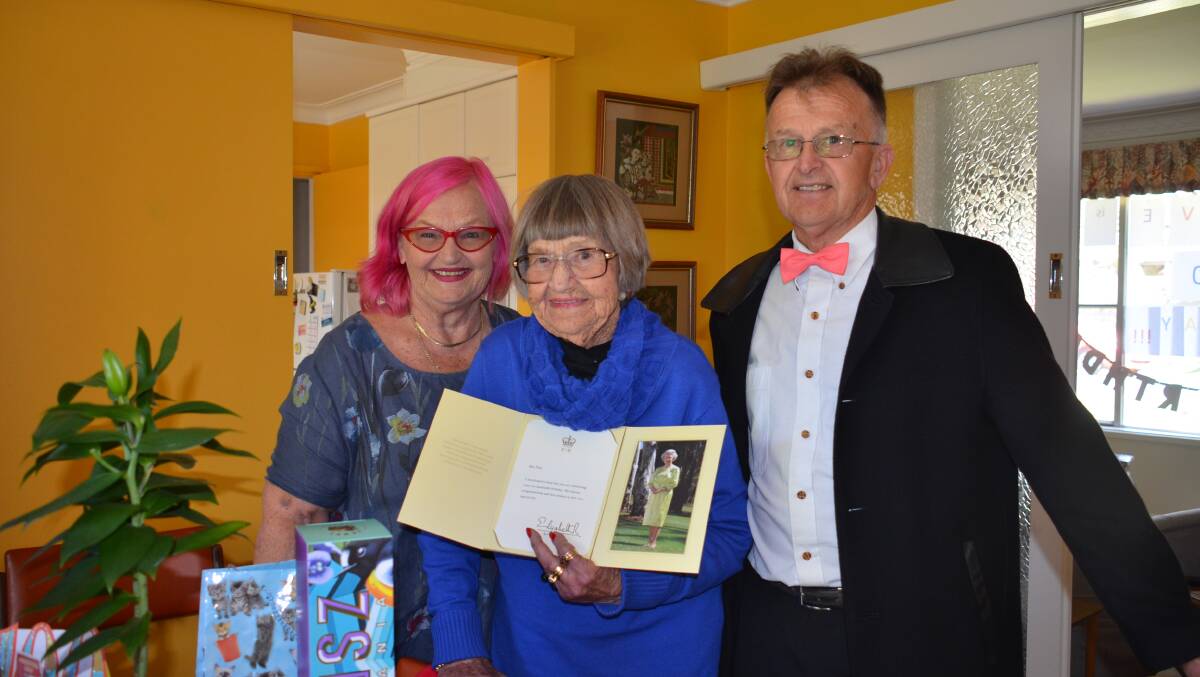 HAPPY BIRTHDAY: Olive Tilly holds her message from The Queen with her daughter Cheryl Landers and son Denis whose birthday is on the same day. photo: Vanessa Arundale