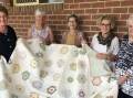 PATCHWORK PRINCESSES: Kenny Richards, Judy Docksey, Annette Hourigan, Robyn Wood and Marg Schaefer with the 2022 quilt prize. Picture: supplied.