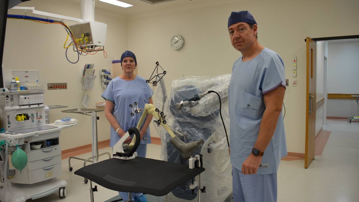 REGIONAL COUP: Armidale Private Hospital CEO Mary Single with Dr Neil Ferguson and the Mako robotic arm. Photo Vanessa Arundale.