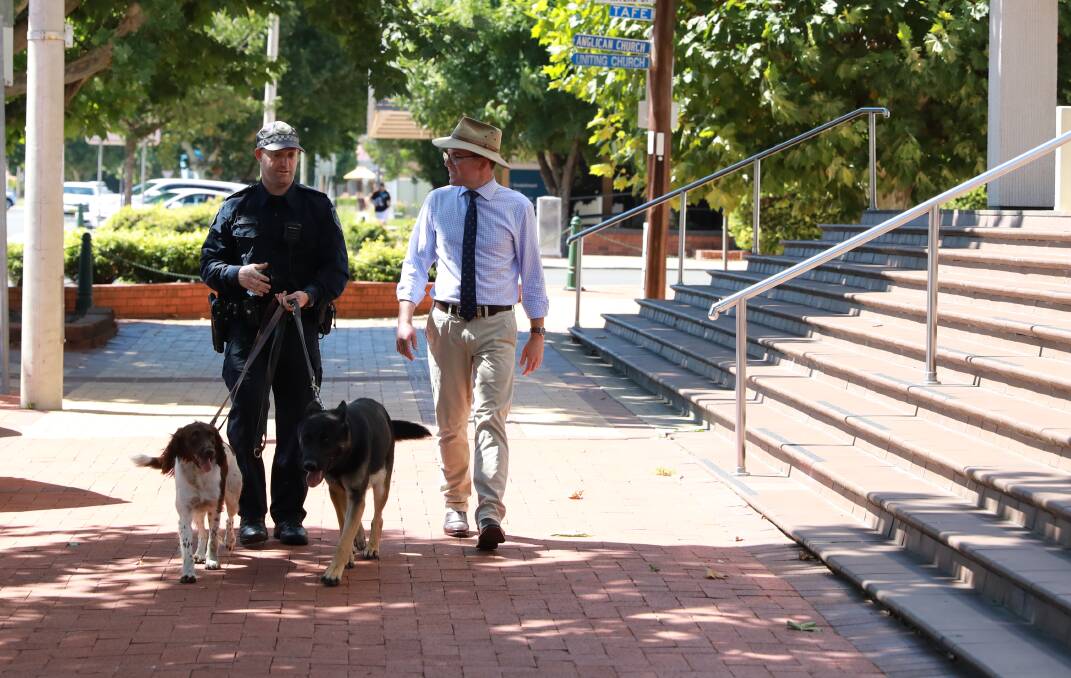 GOING TO THE DOGS: Northern Tablelands MP Adam Marshall on the beat with police dog Atlas and police dog Wags and their handler. Photo supplied.
