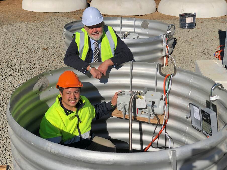  Howard Leong from Key Energy and The Armidale School's Pat Bradley oversee the installation of the flywheels in an innovate energy storage system at The Armidale School