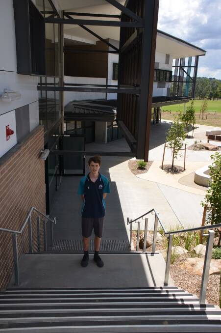 Jordan King stands on the stars leading to his favourite space in the new school - the science labs. Photo Vanessa Arundale.