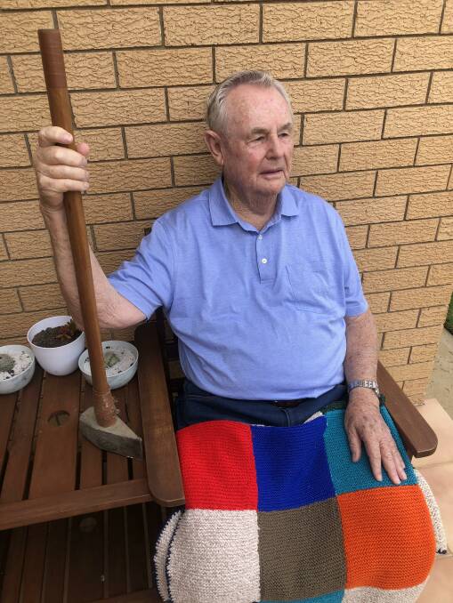 MAN ON A MISSION: Donald Hewitt OAM with his wood splitter and a blanket hand made for him by a woman to mark his 30th year splitting wood for her. Picture: supplied.