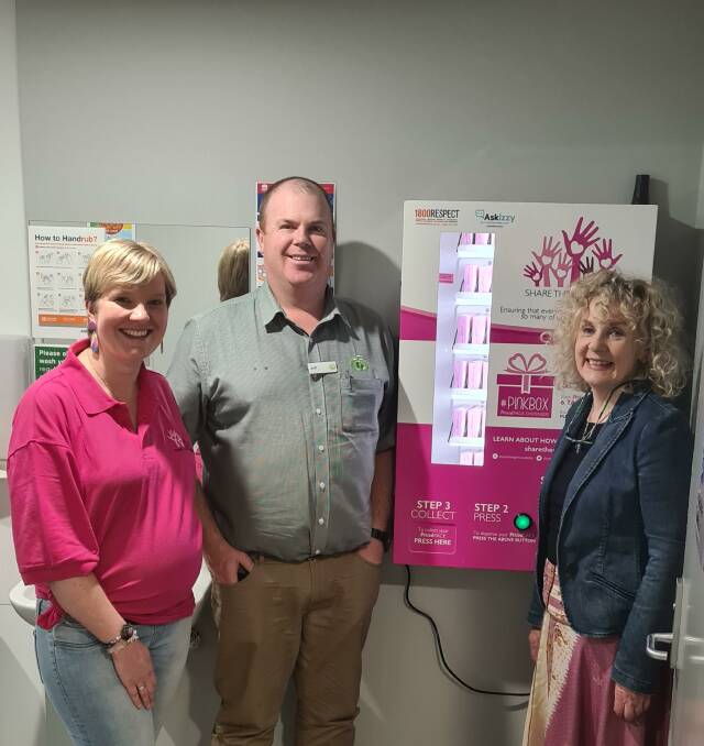 Anne Lane, Jeffrey Carson and Debra O'Brien with the new Pinkbox Share the Dignity vending machine in the Armidale War Memorial Library