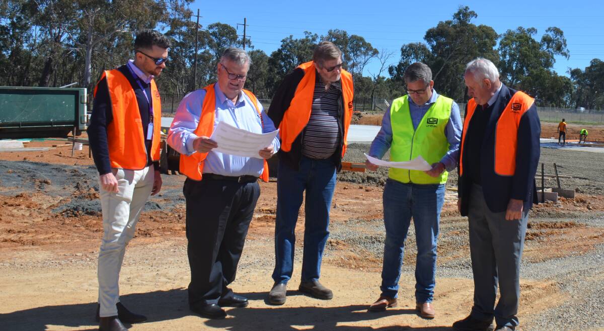 Armidale Regional Council chief officer for sustainability development Dan Boyce and councillors Peter Bailey, Andrew Murat and Ian Tiley review the factory plans with Uniplan managing director Ben Scott at Acacia Industrial Park 