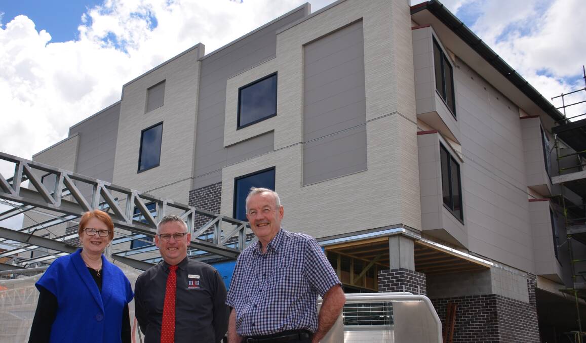 GETTING READY FOR BUSINESS: Rhonda and Dave Gibbons stand in front of the new motel with SerVies CEO Scott Sullivan (centre). Picture: Vanessa Arundale.