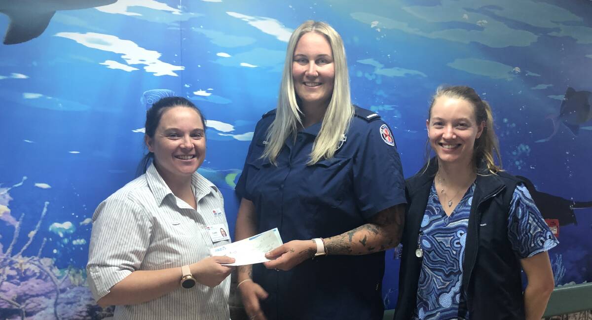 Nurse Unit Manager Clare Horton accepts the cheque from Coyote Cup organiser Clare Moore with nurse Jess Graham in the Armidale Hospital Children's Ward on Friday. Photo: supplied.