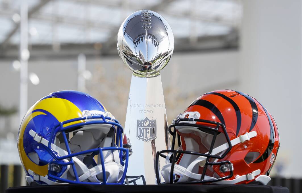 The Vince Lombardi Trophy NFL, flanked by a Los Angeles Rams and Cincinnati Bengals helmet. Photo: EPA/Caronline Brehman