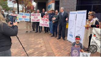 Trains North president Matthew Tierney addresses protesters outside Armidale Regional Council chambers before a decision on funding the first stage of the rail trail.