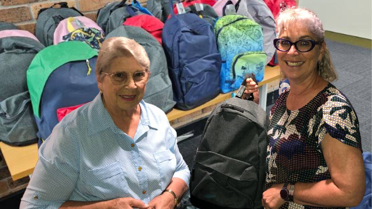 Rotary Club of Walcha member and backpack organiser Lois Hoare delivers the backpacks to Pathfinders staff member Maria Showell.
