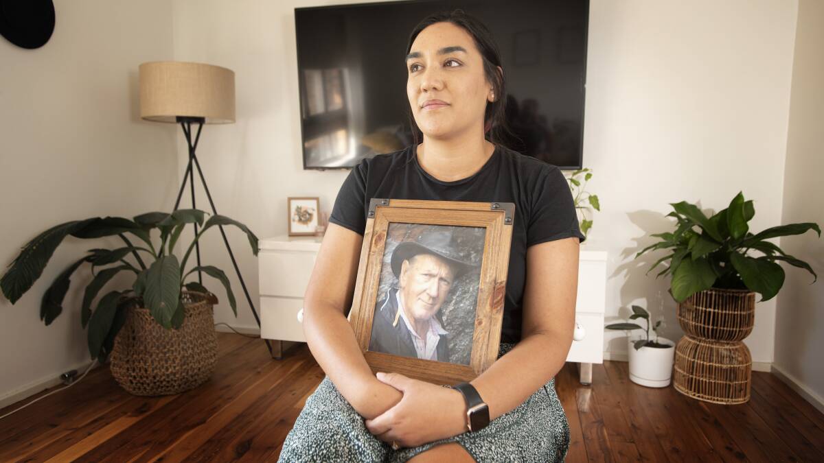 AWARENESS: Naomi Burke, pictured holding a photograph of her father Allan, is calling on people to get checked if something doesn't seem right with their body. Photo: Peter Hardin 