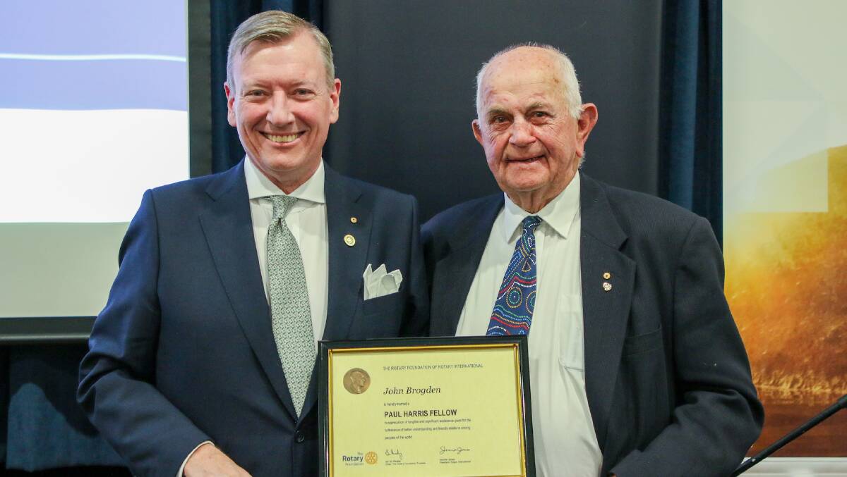 John Wearne, president of Rotary Club of Armidale, awards a Paul Harris Fellowship to John Brogden. Picture by Sam Crick, supplied