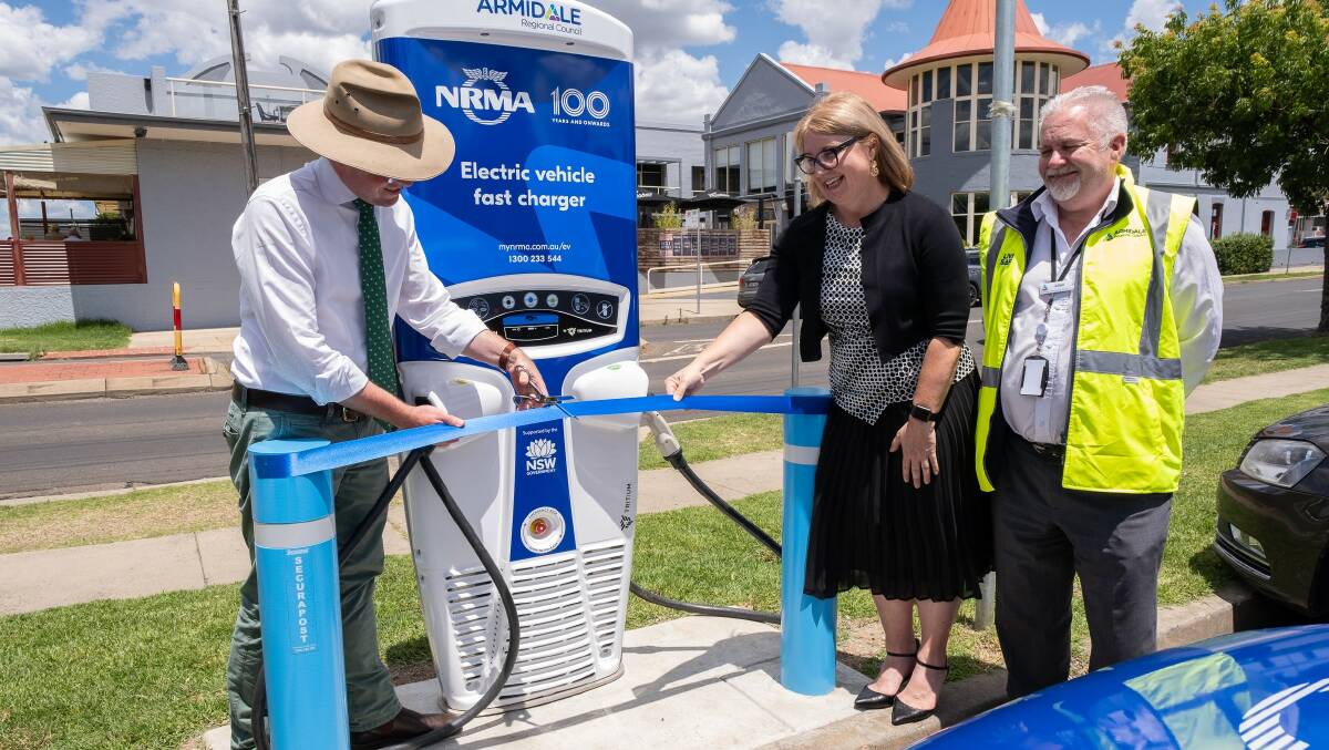 Northern Tablelands MP Adam Marshall cuts the ribbon to officially turn on Armidales new electric vehicle charger yesterday with NRMA E-vehicle Division Manager Suzanne Barbir and Armidale Regional Councils Allan Cooper.