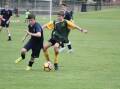 Dax Blair-Previtt (TAS) and Darby Brown (Farrer) compete for the ball in the 14s football.