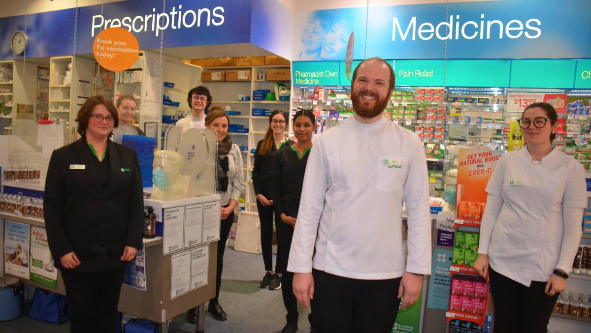 Pharmacist Daniel Flavel (centre) with some of the staff at the chemist. Picture: Laurie Bullock