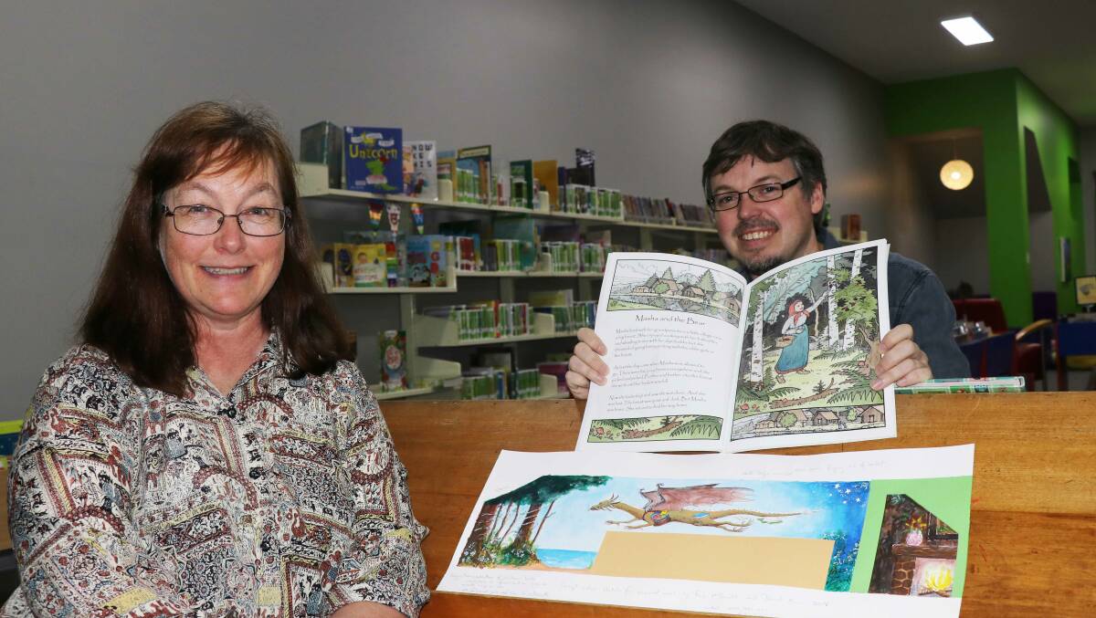 Artists Fiona McDonald and David Allan with the design for the dragon mural and one of David’s illustrations in a book available in Armidale War Memorial Library’s children’s section.