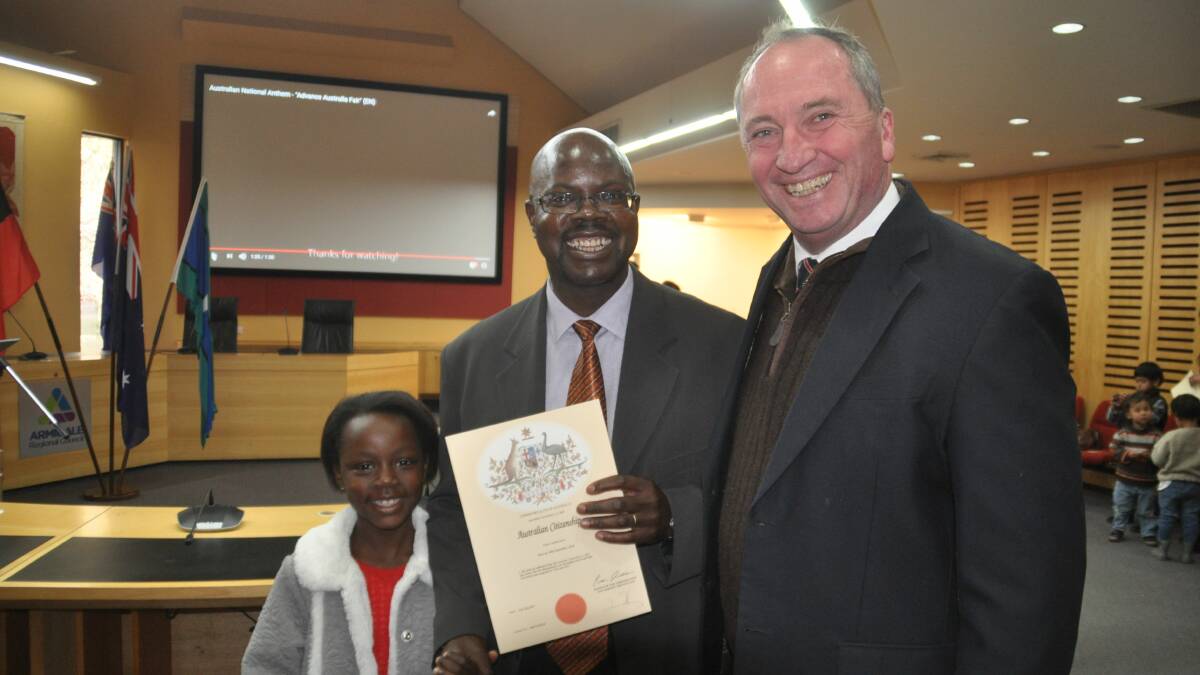 Prof Finex Ndhlovu, a highly regarded linguistics academic, with his younger daughter and acting Prime Minister Barnaby Joyce at the citizenship ceremony. 