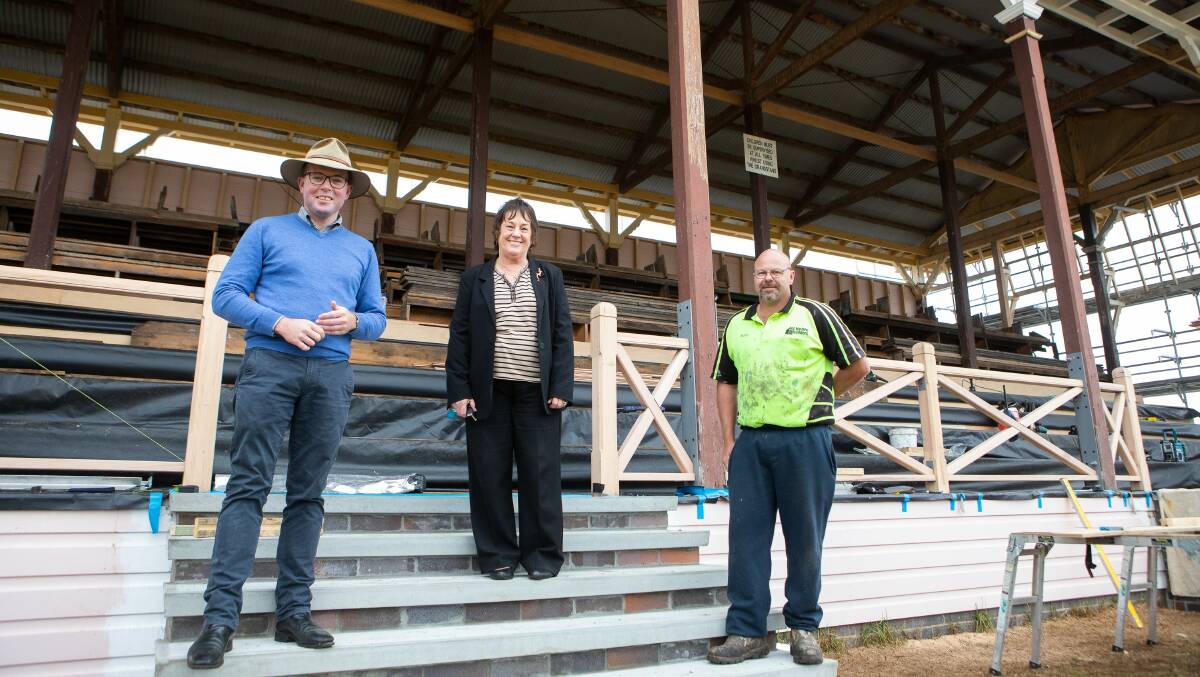 Northern Tablelands MP Adam Marshall, Armidale Showground Reserve Trust Chair June Dangar and builder Nathan Noble on the steps of the eastern grandstand, which is currently undergoing restoration works.