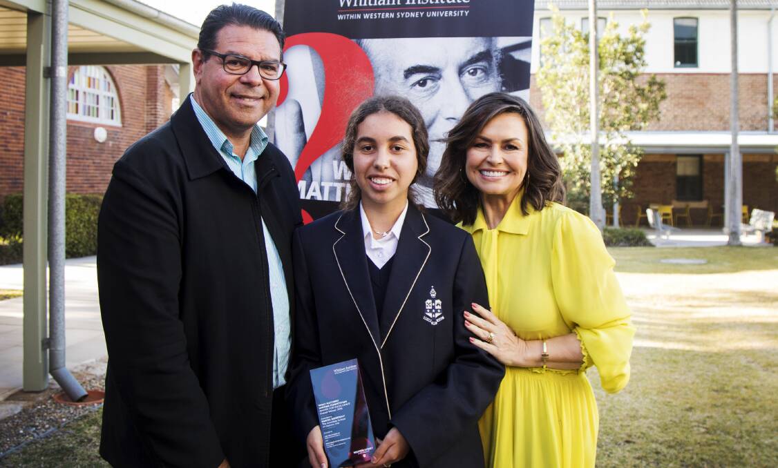 Sancia Ridgeway is presented with her award by competition patron and television presenter Lisa Wilkinson, watched by her father Dr Aden Ridgeway