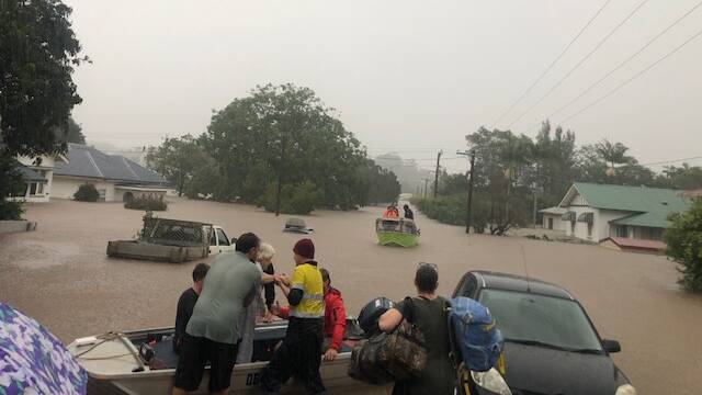 Local residents in Lismore help with rescue efforts during last week's flood. Picture: Rod Harris