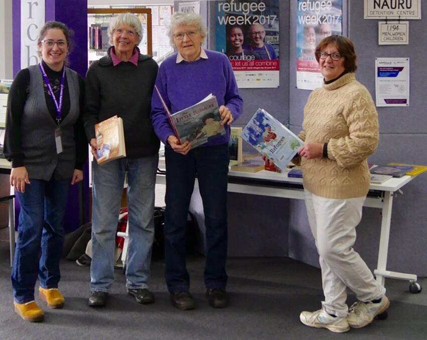 Librarian Lucia Perez and Armidale Rural Australians for Refugees supporters Patsy Asch, Bar Finch and Elizabeth O'Hara in front of the display for Refugee Week, 2017.