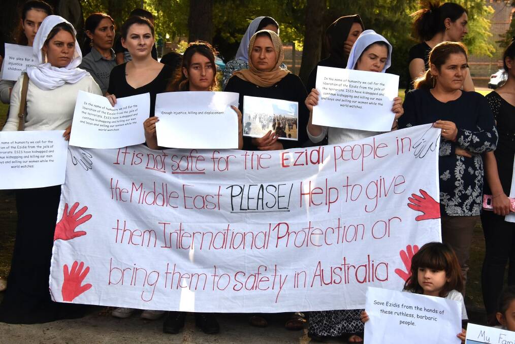RALLY: Ezidi women and their Armidale friends mourn for 50 women found murdered last year. Photo: Nicholas Fuller