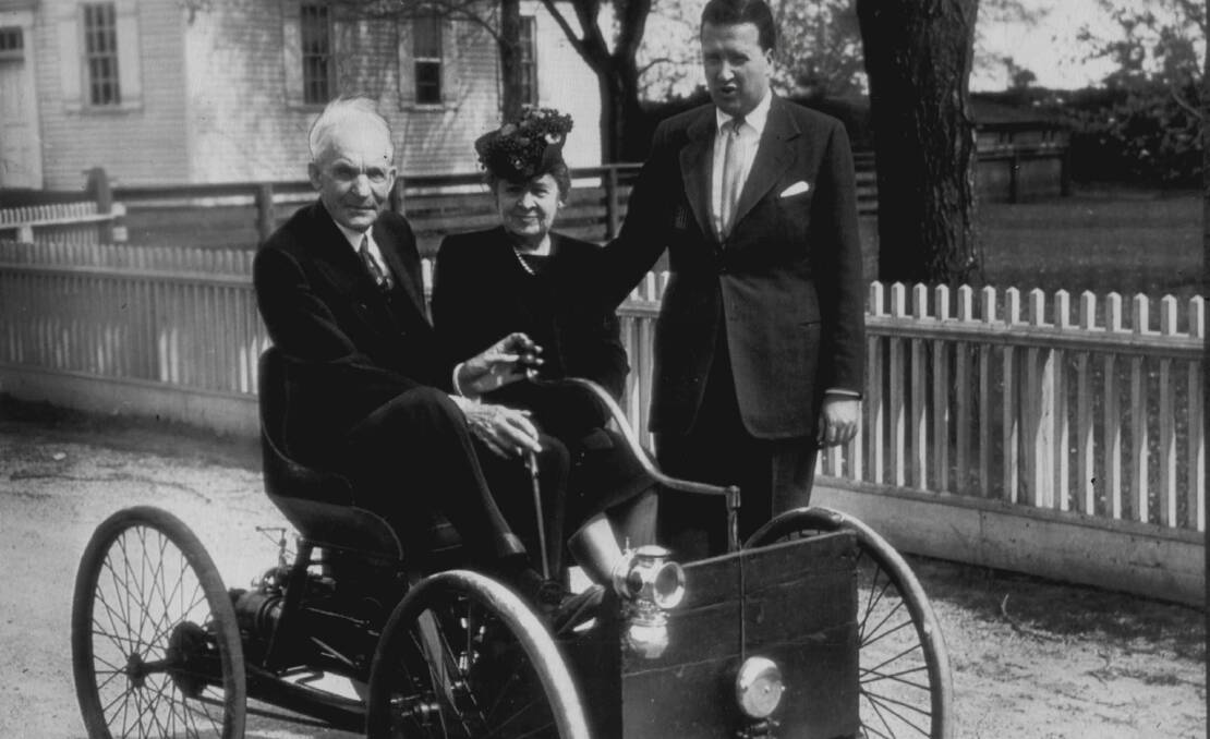 Sitting in the first machine he built (in 1896) is Henry Ford, founder of the Ford Motor Co., The photo was taken in 1946 ahead of the celebration of Detroit's automotive golden jubilee, which honoured Ford and other auto pioneers. Mrs. Ford sits beside him and standing is Henry Ford II.