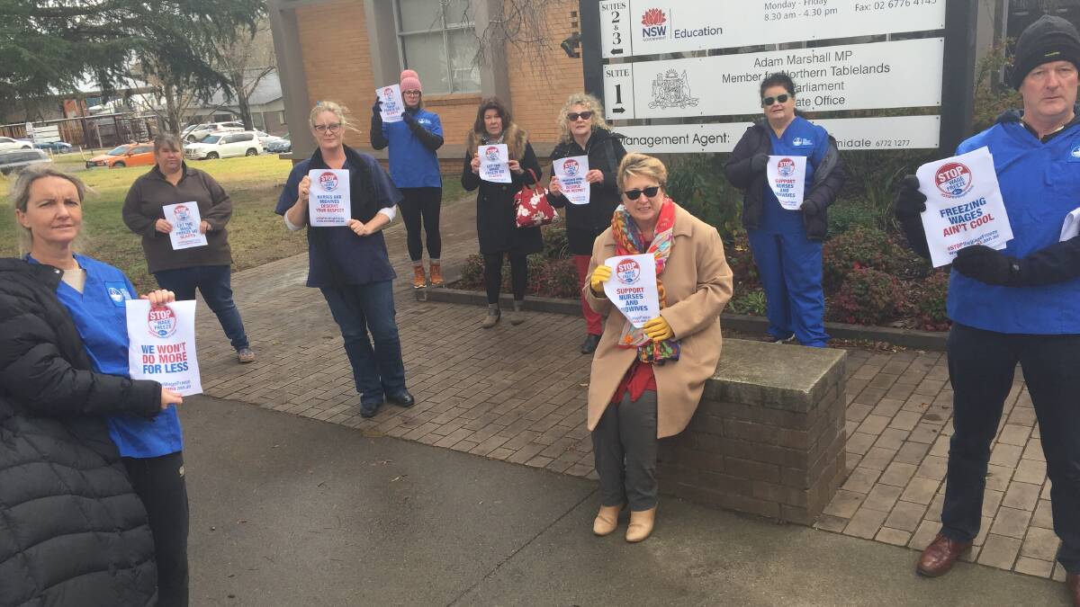 Local Nurses and Midwives Association president Jo Sillitoe (left) and secretary Warren Isaac (right) were joined by union members to protest outside Adam Marshall's office.