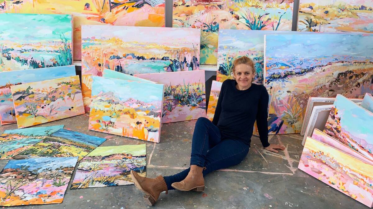 Paula Jenkins in the studio with her Riverbeds & Spinifex paintings.