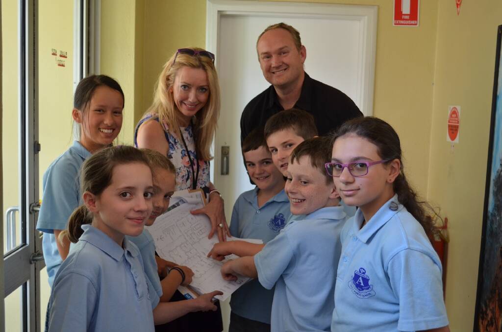 Matt Rees, Sonia Broun and Armidale City Public School students look closely at a Development Application.
