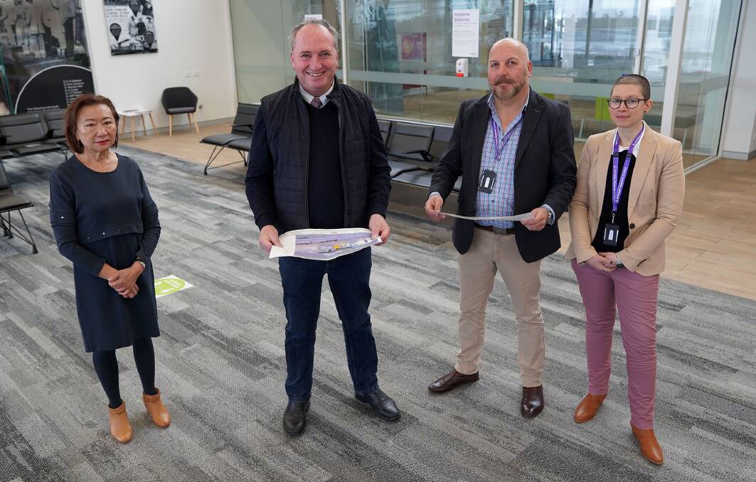Armidale Regional Council CEO Susan Law, Member for New England Barnaby Joyce, Airport Manager Billy Gleeson-Barker and Project Officer Lilian Colmanetti review concept drawings of the new security screening. 