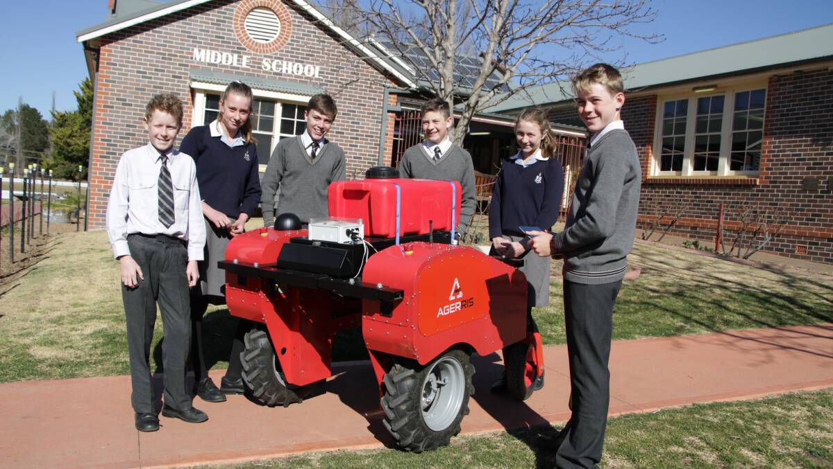 Year 8 STEM students Tom Slack-Smith, Holly Crawford, Samuel Atkin,
Jonathon Phelps, Emily Buntine and Louis Ross take delivery of the Digital Farmhand robot that will be used as a teaching resource to STEM, technology, electronics and agriculture students at TAS this term.