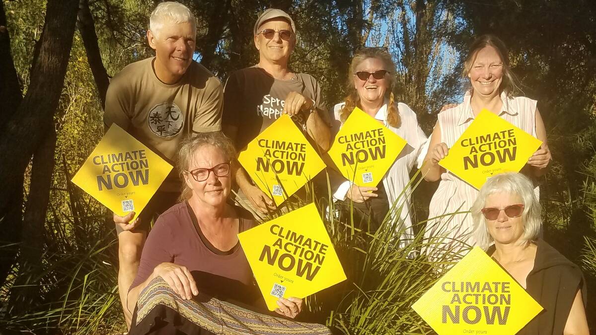 The sign you'll see everywhere: Rob Nabben, Garry Slocombe, Nikki Rochford, Jodi Jardine, Annette Kilarr and Bea Bleile from Sustainable Living Armidale with the climate action now signs. Picture: Supplied