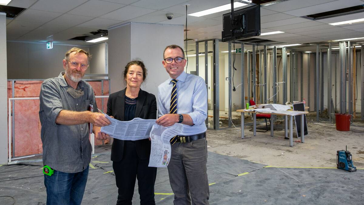 PLANS IN PLACE: Surveying plans inside the new Armidale Community Hub, which is still under construction, Homes North Community Housing Partnerships & Projects Co-ordinator Andrew Parker, Homes North CEO Maree McKenzie and Northern Tablelands MP Adam Marshall.