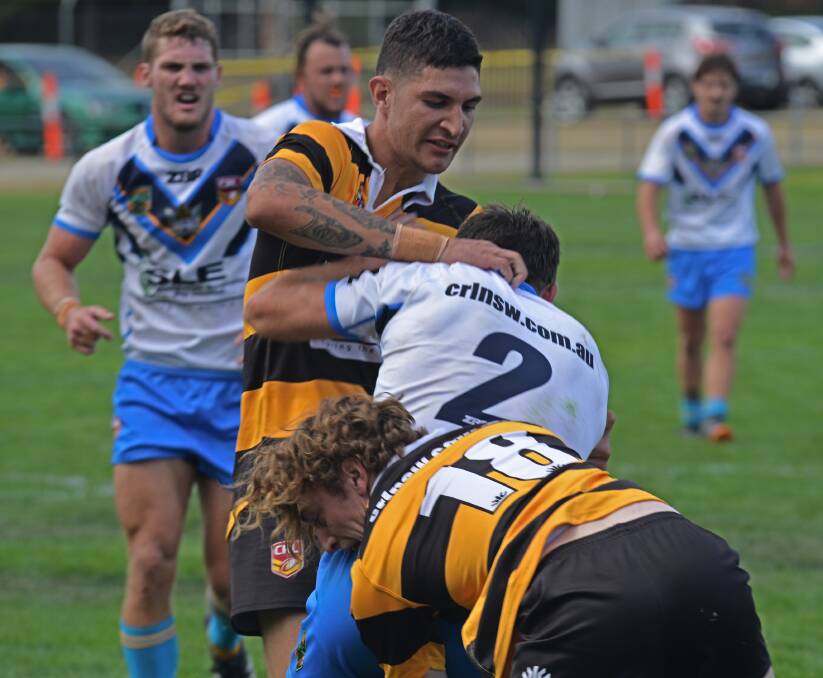 TIGER TRAP: Greater Northern centre Tristan Ward (up high) and winger Harry Douglass take down Titan No.2 Michael Dwane. 