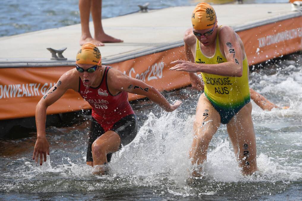 Backhouse and England's Vicky Holland lead the race out of the water. Photo: AAP/Dean Lewins
