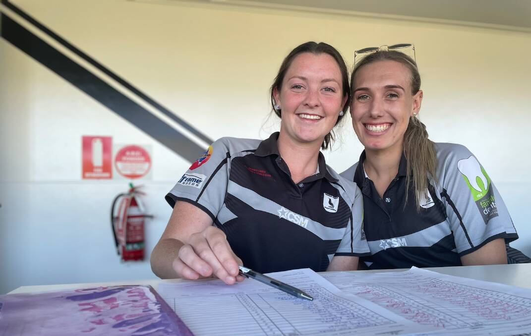 PIES TIME: James and her good friend and Werris Creek teammate, Dayna Porter, in the scorer's box at David Taylor Oval this month. Photo: Mark Bode