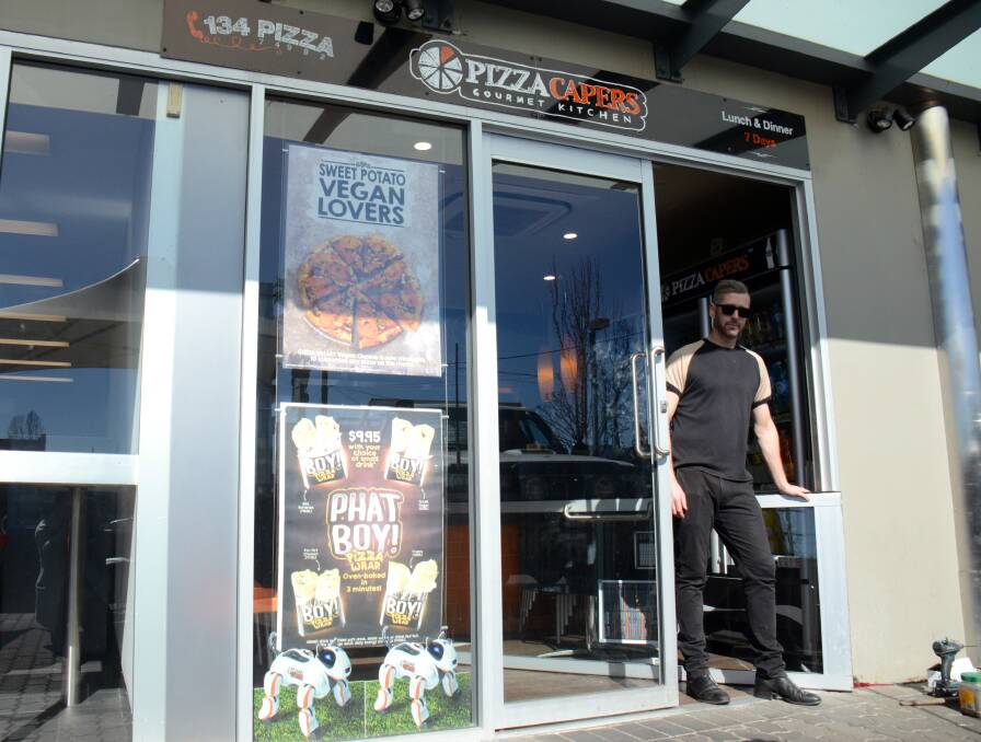 BREAK-AND-ENTER: Armidale Pizza Capers owner Adam Hayes arrives at work on Tuesday morning to find police following overnight break-in. 