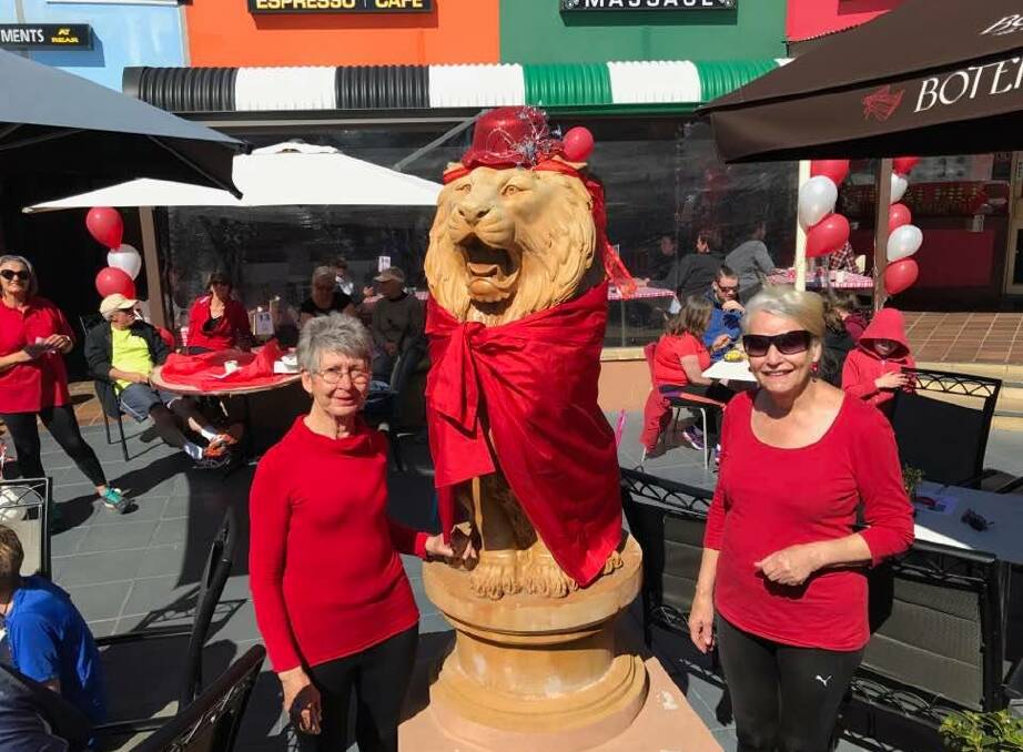 Margaret Watts and Nancy Burton had a busy morning decorating the lion before the fundraiser at Westside Espresso on Saturday. Photo: Rachel Baxter.