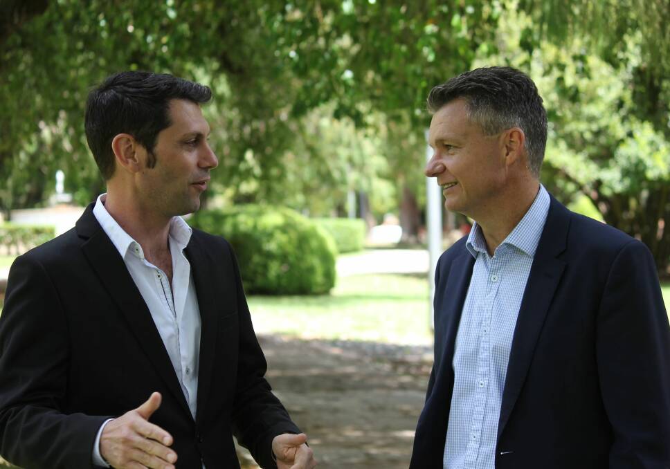 MAKING BANKS HONEST: Labor candidate David Ewings joins Shadow Assistant Minister for Treasury Matt Thistlethwaite at Armidale's Central Park on Friday. Photo: Rachel Baxter.