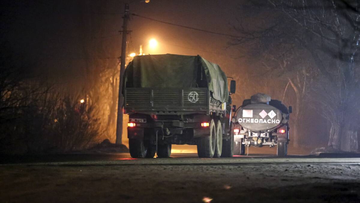 Military trucks move down a street outside Donetsk, the territory controlled by pro-Russian militants, eastern Ukraine, late Tuesday, Feb. 22, 2022. Photo: AP Photo