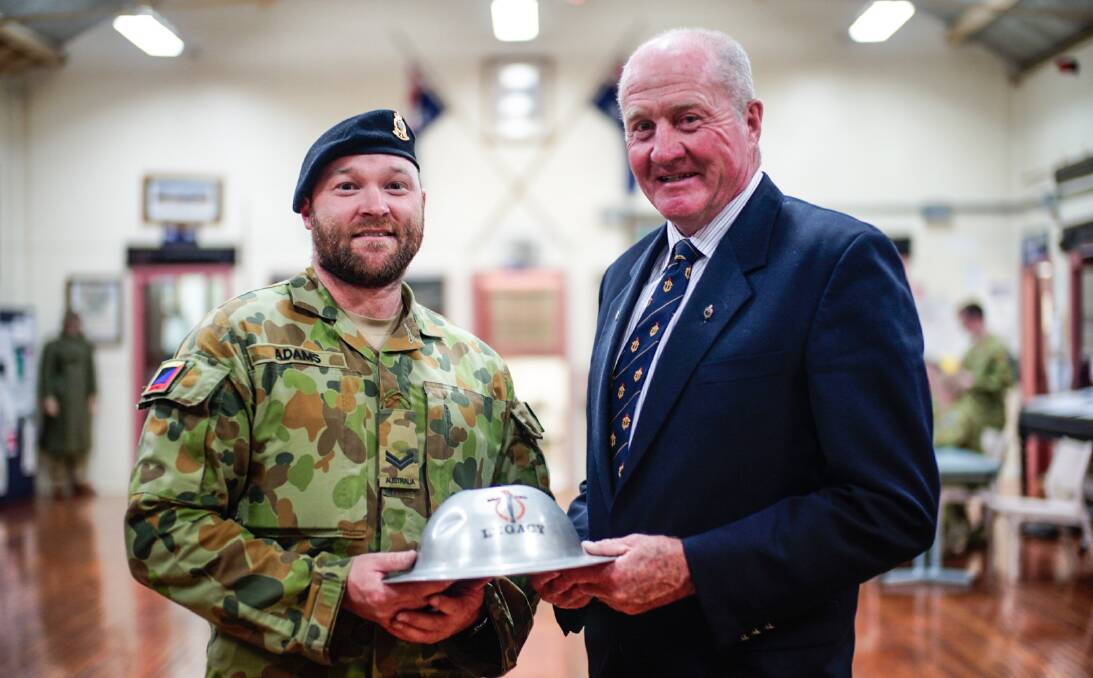 The Legacy Club of Armidale president Grant Harris with corporal Mark Adam, who has grown a bead for the past month to raise money for the widows and families of war veterans, in the Hunter River Lancers base in Armidale.