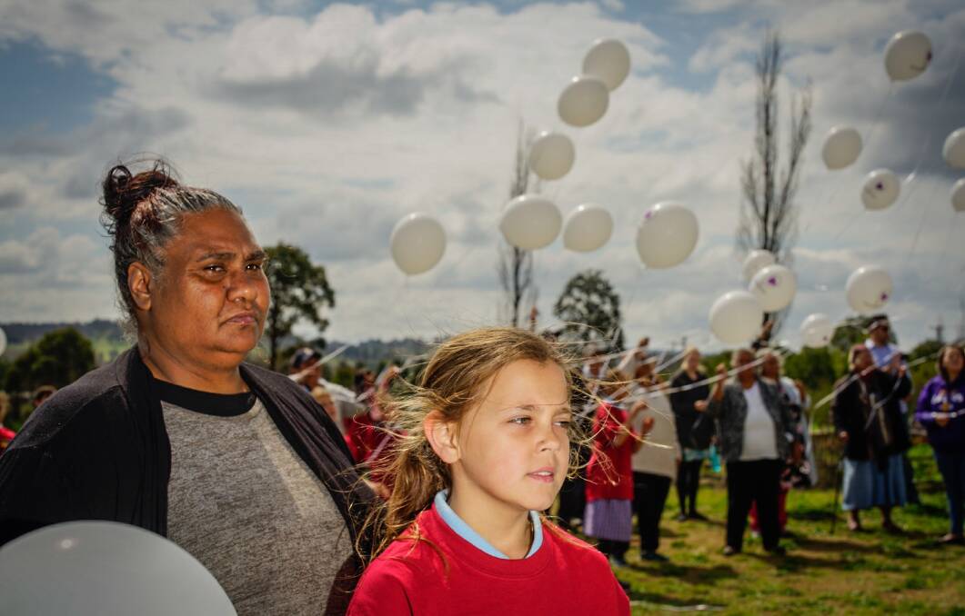 Nioka Chatfield and year 5 student Loc-Keesha Vale, 10, release balloons for White Balloon Day.