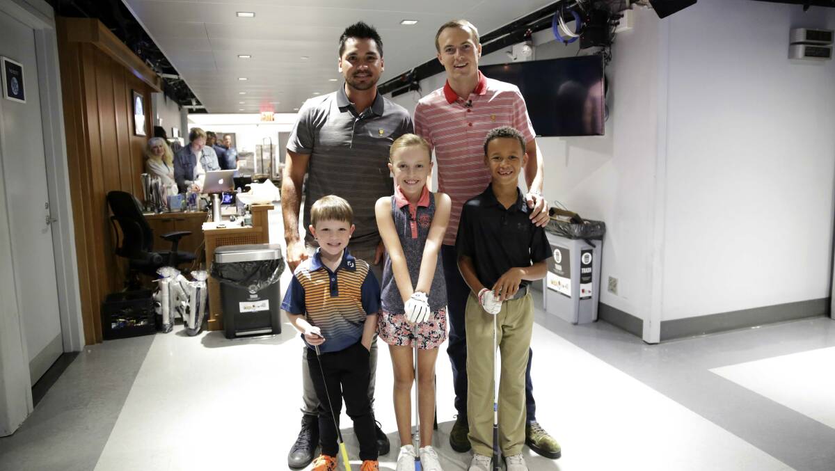 Jason Day and Jordan Spieth with youngsters Isaac Riches, Madison Moman and Aiden Dinani. 