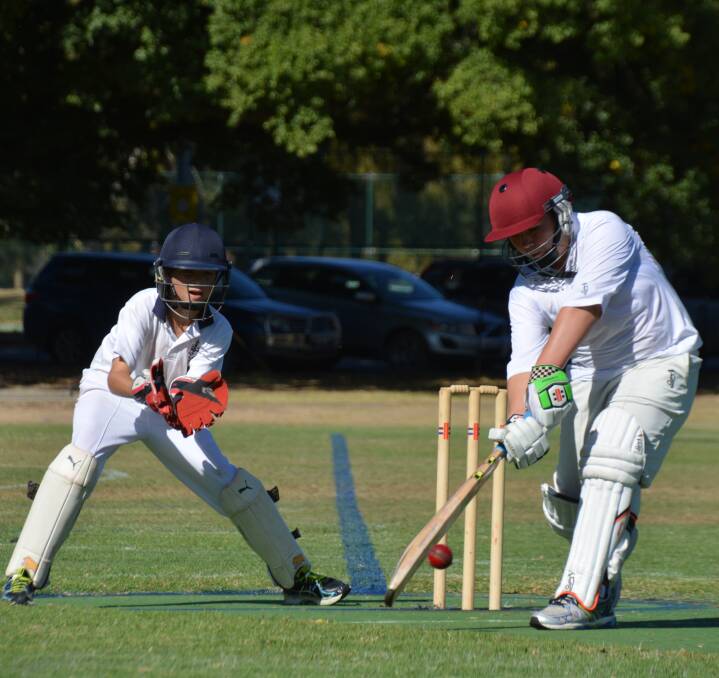 TAS' Toby Smith behind the stumps with Ex-Services' Ben Murphy at the crease last season. 