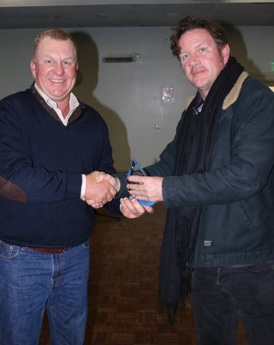 HELPING HAND: Yarrowitch's Neil Dunn was presented with the volunteer of the year award by Tamworth AFL president Adrian Walsh at last weekend's presentation dinner. 