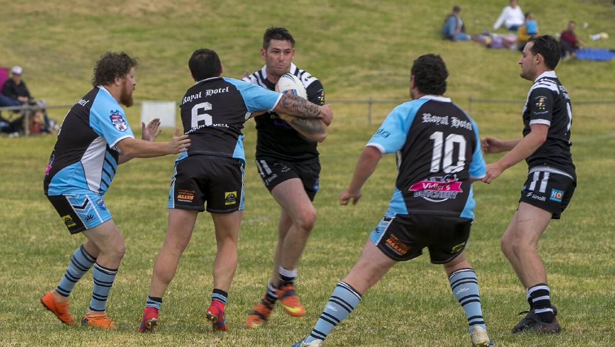 HIT UP: Jack Miller is greeted by the Guyra defence. Photo: Andrew Hoggan. 